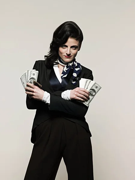 Businesswoman holding money isolated on white background