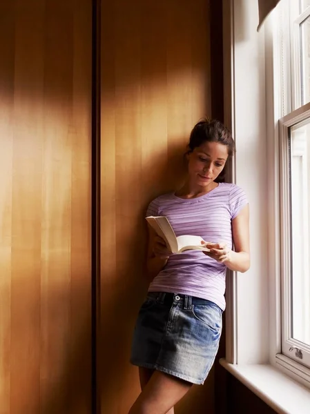 young woman with book in the room