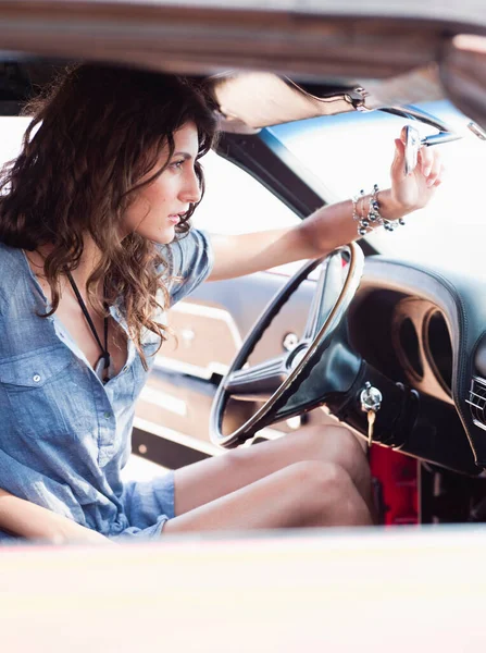 woman sitting in front seat of car