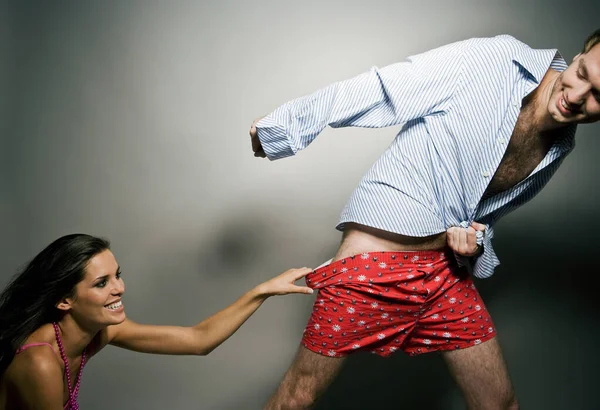 Woman Pulling Man Underwear — стоковое фото
