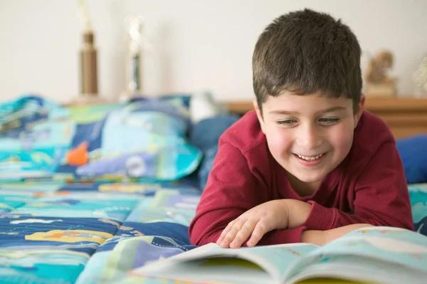 Boy Reading Book Smiling — kuvapankkivalokuva