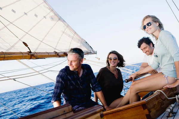 two couples on a sailing boat smiling