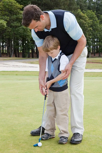 Father Teaching His Son Golf Stock Photo