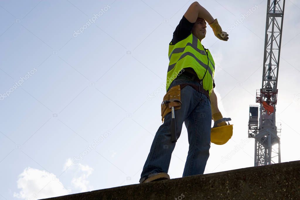 Construction worker over blue sky 