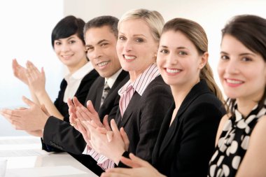 A line of business people clapping