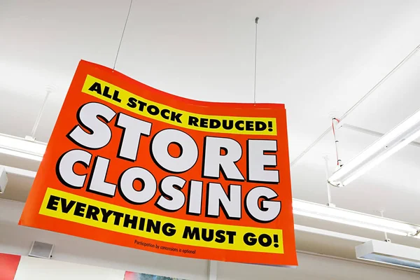 Store closing sign on ceiling