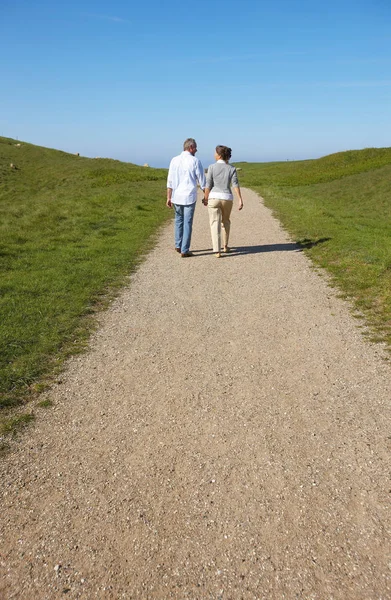 Mature couple walking away together