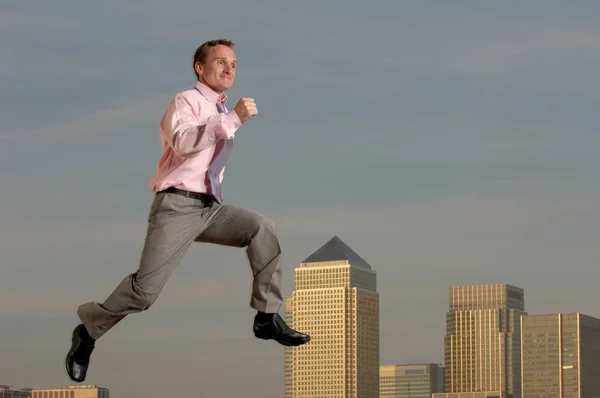 inspired businessman running over cityscape