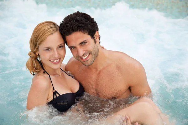 Young couple in hot tub, portrait