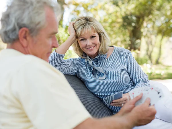 Mature couple playing cards outdoors