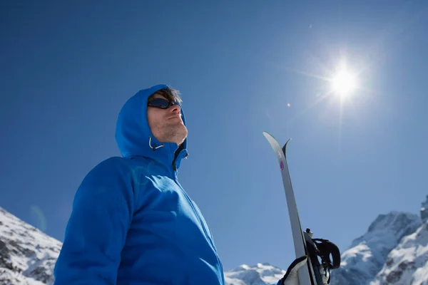 Man with cross-country ski in winter