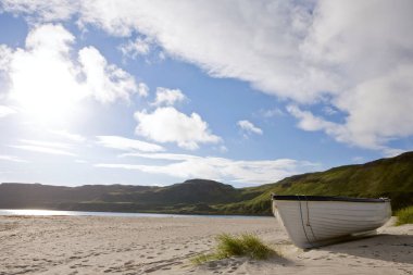 A rowboat on a beach on the isle of mull clipart