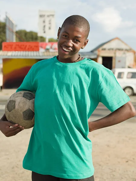 Teenage african boy with football