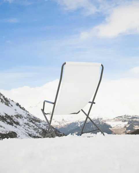 Deck chair overlooking mountain scene