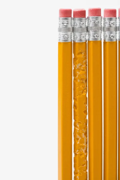 One bitten pencil amongst new pencils — Stock Photo, Image