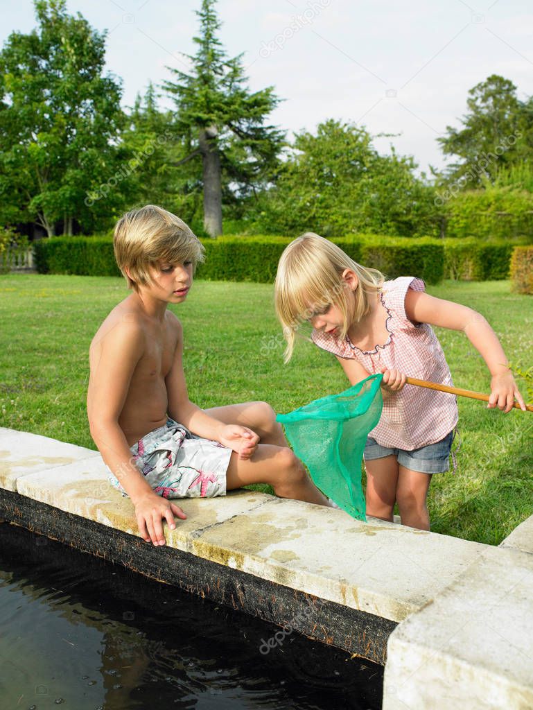 Kids fishing in a pond