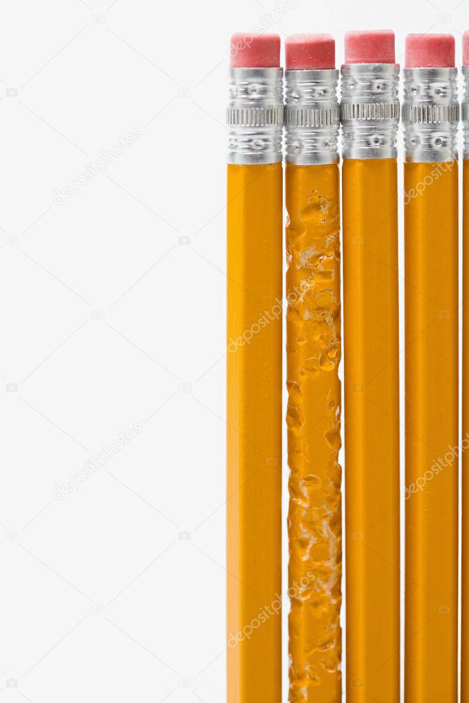 One bitten pencil amongst new pencils