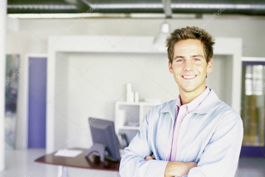 Man in an office smiling 