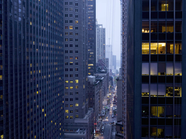 Elevated view of rush hour between skyscrapers at dusk, New York, USA
