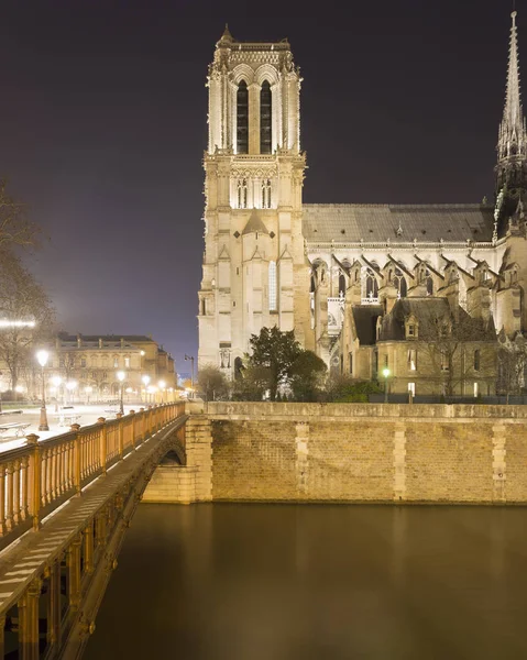 View of Notre Dame Cathedral and Pont au Double at night, Paris, France Royalty Free Stock Photos
