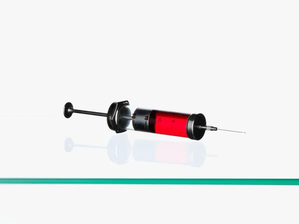 Syringe containing red liquid — Stock Photo, Image