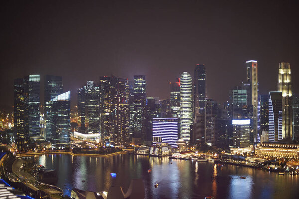 View of skyscrapers on waterfront at night, Singapore