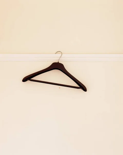 Empty hanger hanging on wall — 스톡 사진