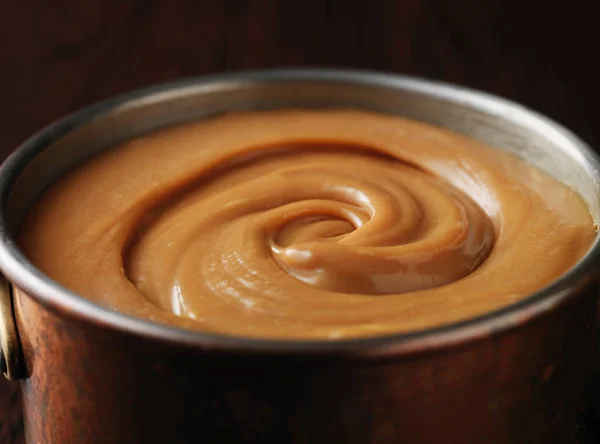 Still life with pan full of salted caramel — Stock Photo, Image