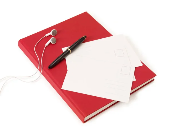 Livro postais caneta e fones de ouvido — Fotografia de Stock