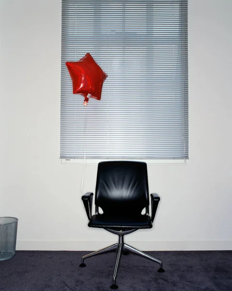 Balloon attached to office chair — 스톡 사진