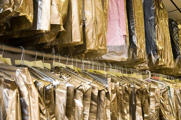 Dry cleaning hanging on a clothes rail — Stok fotoğraf