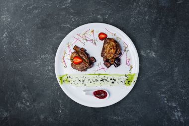 Kaz ciğeri üzerinde tatlı patlıcan ile dana madalyon.