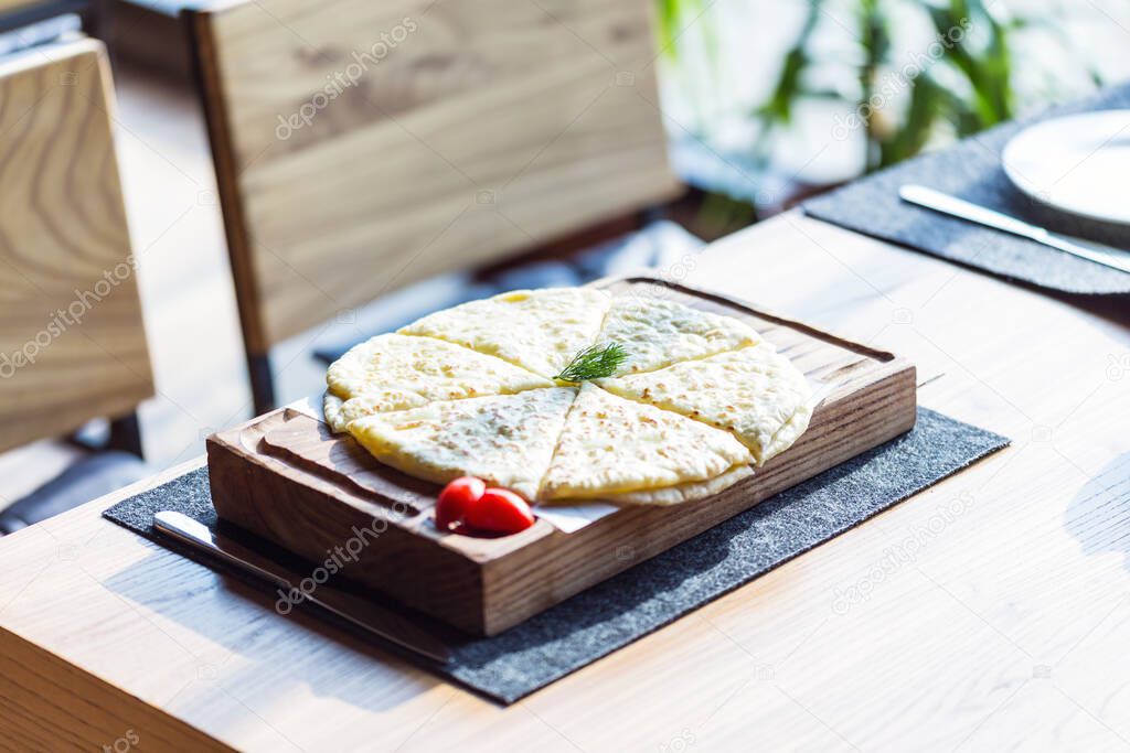 hychiny, tortilla dough with cheese and potatoes, on cutting board