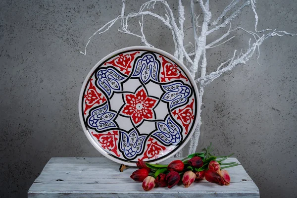 Decorative, painted plate on a gray background. — Stock Image Decorative Painted Plate Gray Background Stock Picture