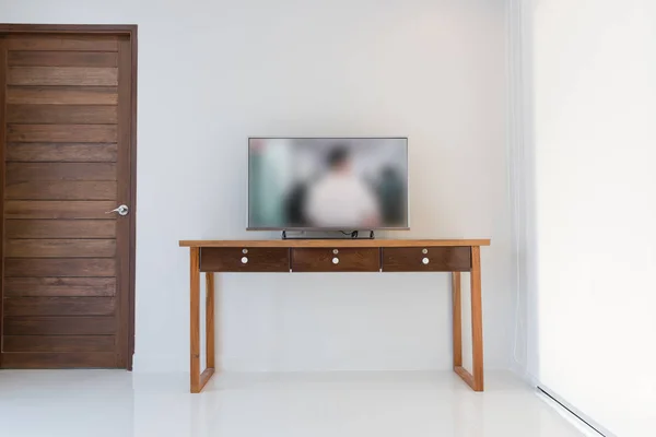 Led smart TV on wooden shelf over white wall backgroundn modern