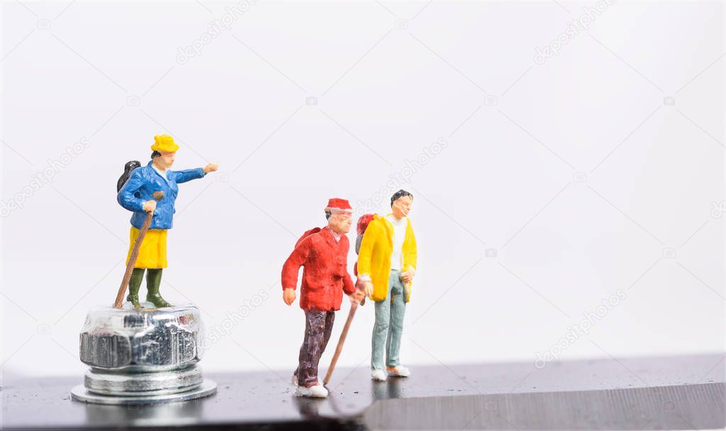 Miniature traveller and backpacker teamwork isolated on white background,leadership teamwork success in business