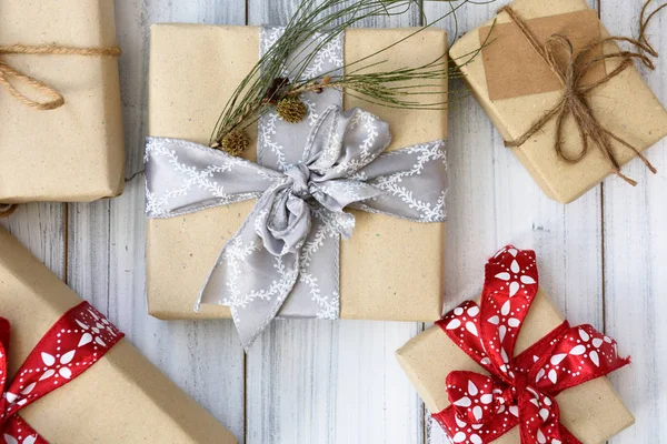 Karácsonyi barna díszdobozok csomagolva a piros szalag meg fehér — Stock Fotó