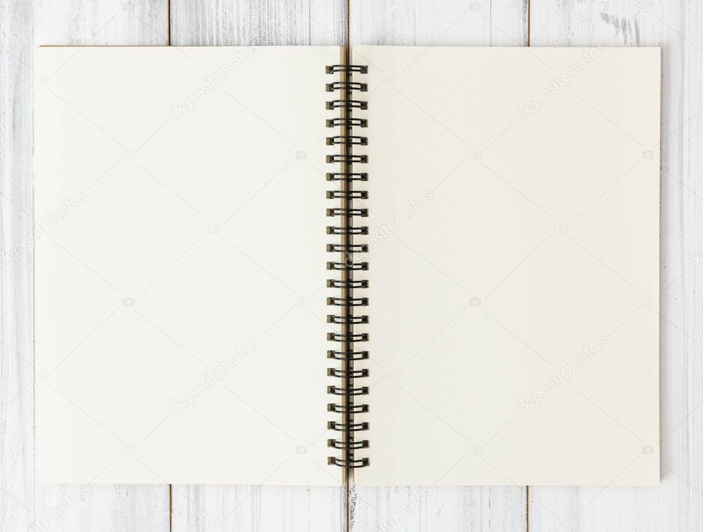 Open notebook on white wood table background,flat lay