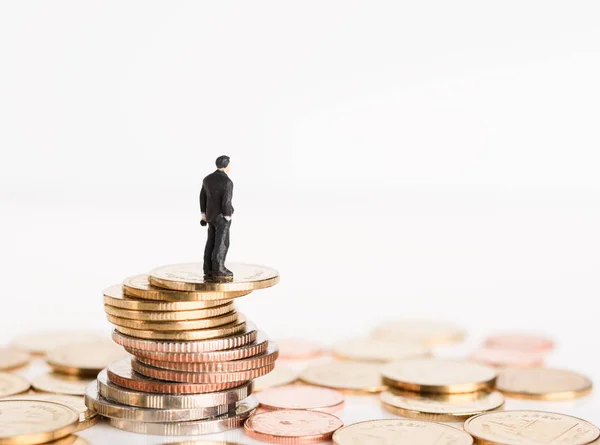 Miniature business people stand on money coins isolated on white — Stock Photo, Image