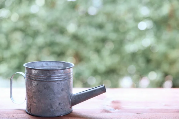 Galvanized Watering Can Wooden Table Nature Green Blurred Background — Stock Photo, Image
