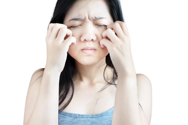 Scratching her face or cheek in a woman isolated on white background. Clipping path on white background. — Stock Photo, Image