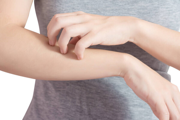 Scratching her arm in a woman isolated on white background. Clipping path on white background.
