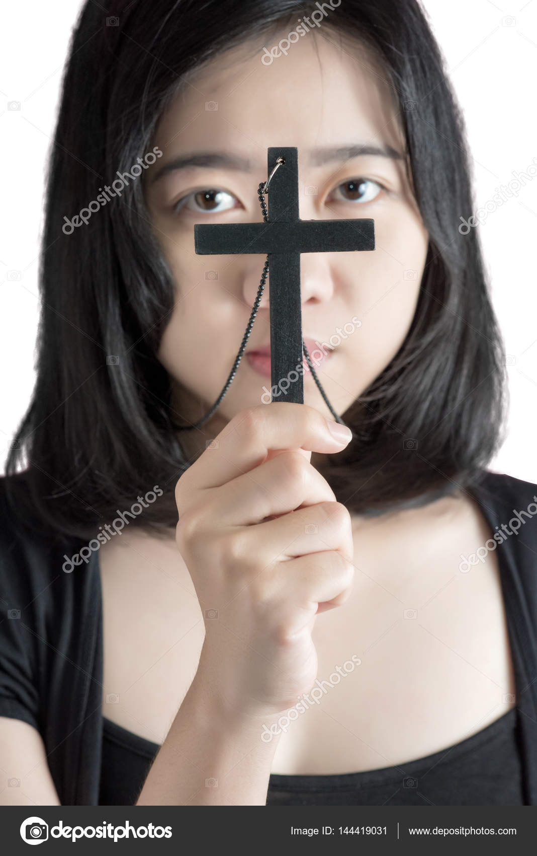 Beautiful asia woman with hopeful holding christian symbol of crucifix  praying to God isolated on white background. Clipping path on white  background. Stock Photo by ©chatchaiba 144419031