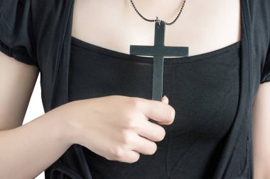 Güzel Asya kadın umutlu holding Hıristiyan sembolü haç beyaz arka plan üzerinde izole Tanrı'ya dua ile. Beyaz arka plan üzerinde kırpma yolu.