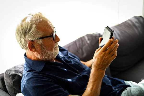 Senior Man Sitting Alone Relaxation Playing Game Smart Phone Home — 스톡 사진