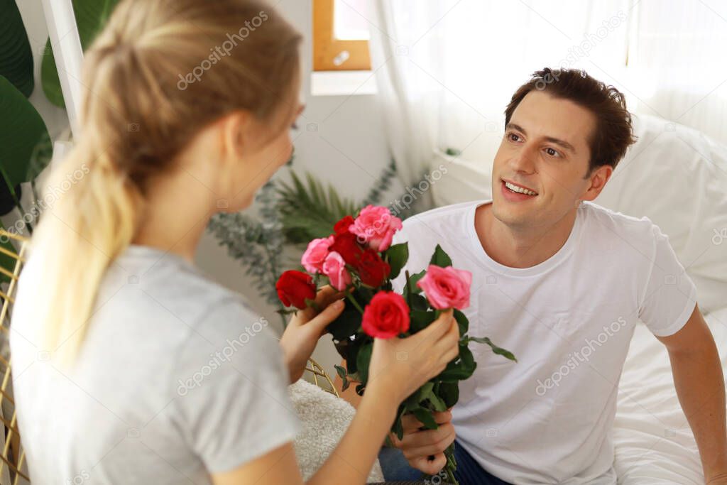 Young couple lover surprise give rose flower in valentine's day.	