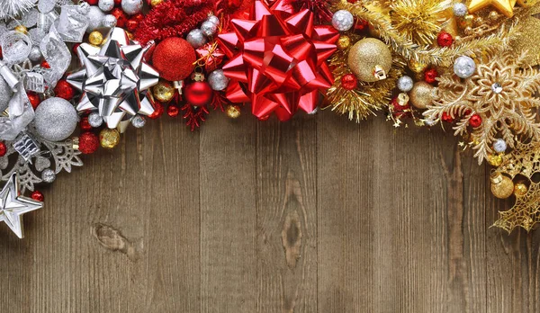 Christmas bows, ornaments, and decorations on wooden background — Stock Photo, Image