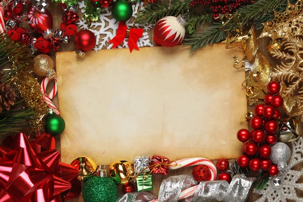 Blank paper surrounded by Christmas ornaments, decorations, and — Stock Photo, Image