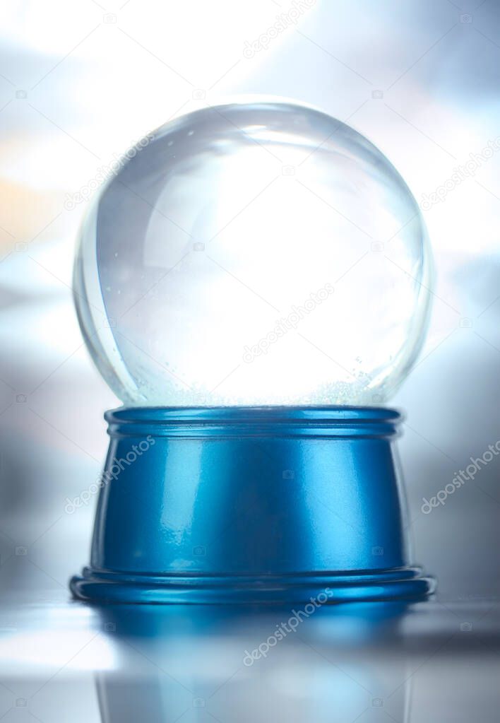 Blank empty snowglobe. Glass snow globe on blue base.