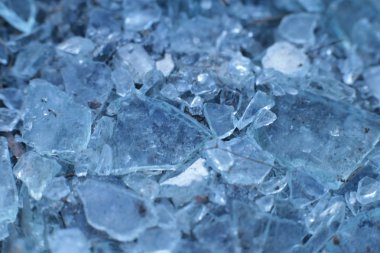 Küçük, keskin cam parçaları ve buz mavisi parçalar.